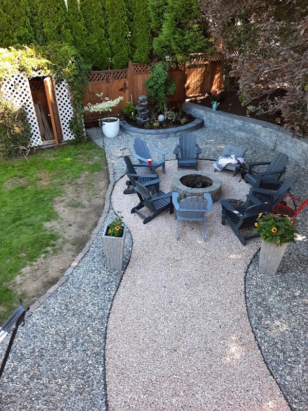 Gravel fire pit lounge with Adirondack chairs