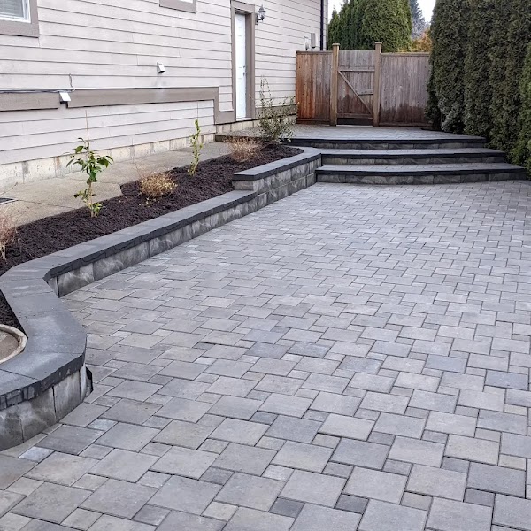 Paver patio with curved steps and planting bed