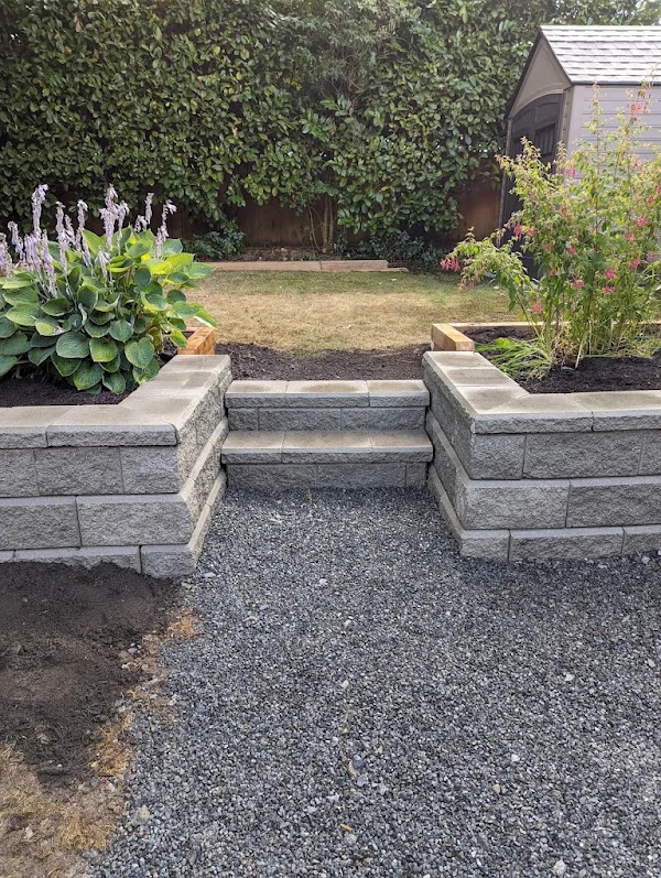 Concrete block retaining wall with built-in steps