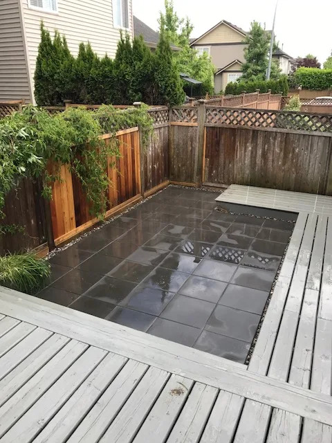 Dark porcelain tile patio set into a wood deck
